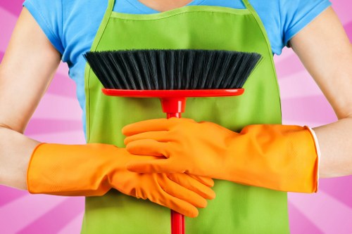 Cleaner preparing a safe cleaning workspace with protective equipment